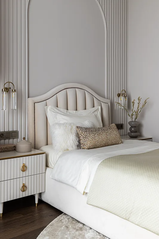 Bed with quilted upholstered headboard and bedside table