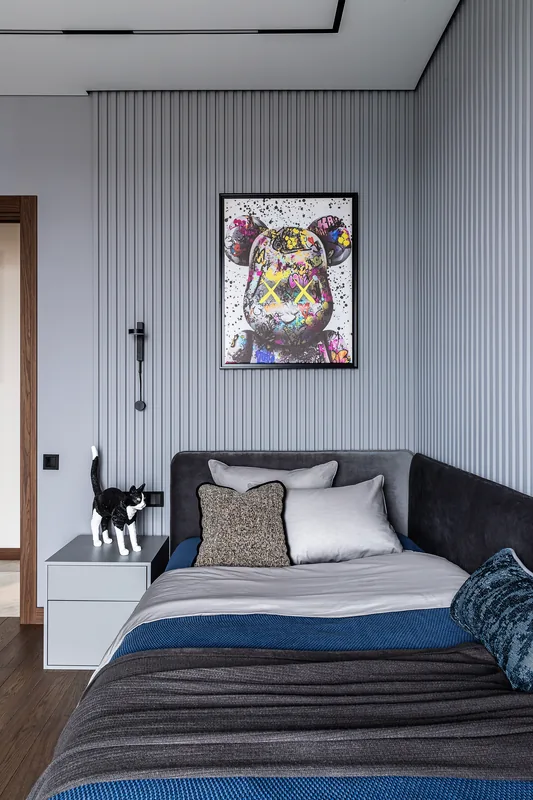 Bed with upholstered headboard against wall slats