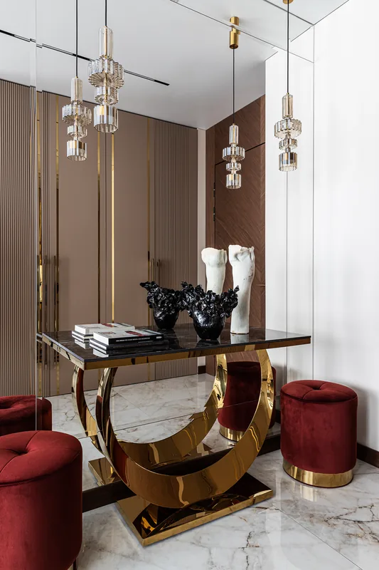Console table and soft poufs in the entryway