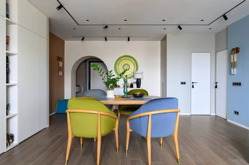 Dining room: tall cabinet with open shelves and dining set by the archway