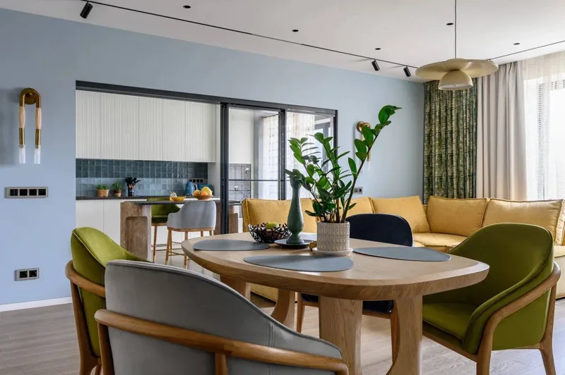 Dining area by the kitchen: round table, armchairs and corner sofa